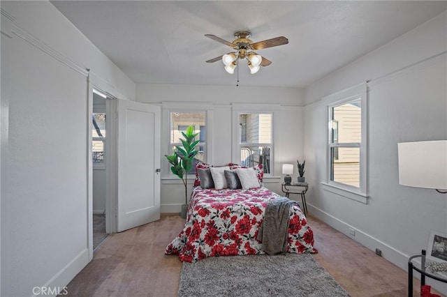 carpeted bedroom featuring ceiling fan