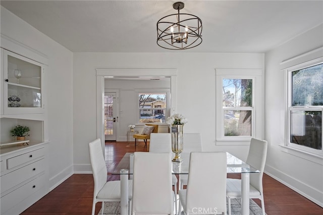 dining room with dark hardwood / wood-style floors, a chandelier, and a healthy amount of sunlight