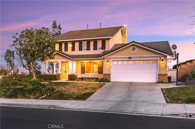 view of front of home with a garage and a porch