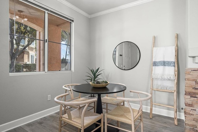 dining area with dark wood-type flooring and crown molding