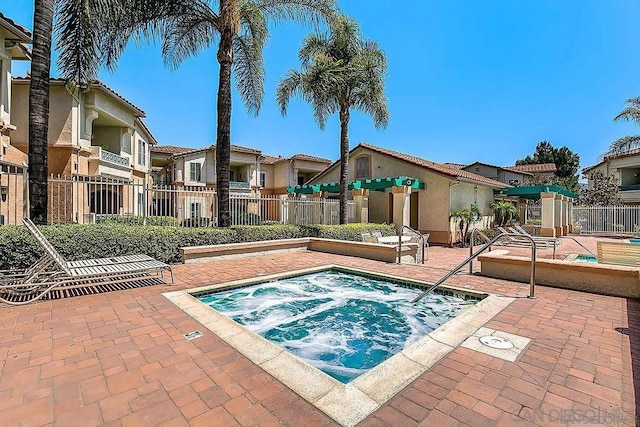 view of pool with a community hot tub and a patio area