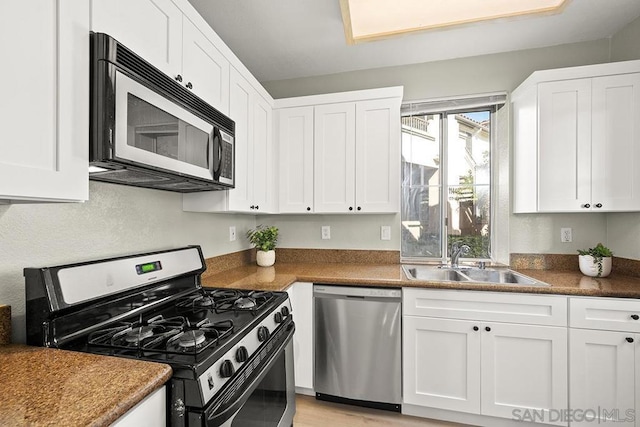 kitchen with white cabinets, sink, and stainless steel appliances