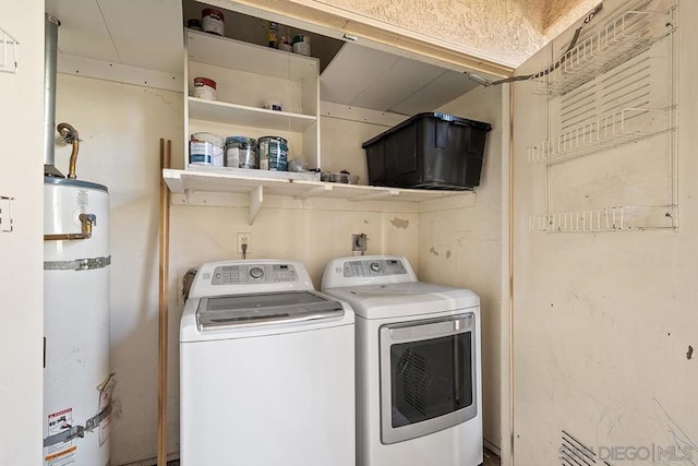 clothes washing area with washer and dryer and secured water heater