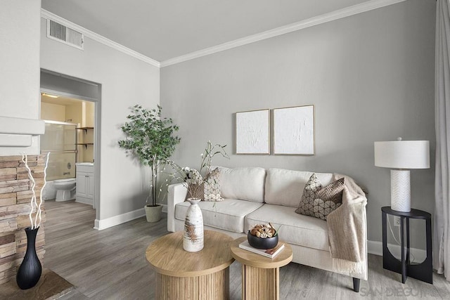 living room featuring ornamental molding, hardwood / wood-style floors, and built in shelves