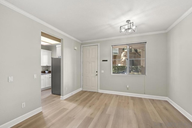 interior space featuring ornamental molding and light hardwood / wood-style flooring