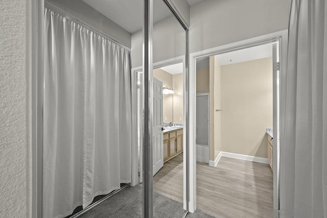 bathroom featuring hardwood / wood-style flooring and vanity