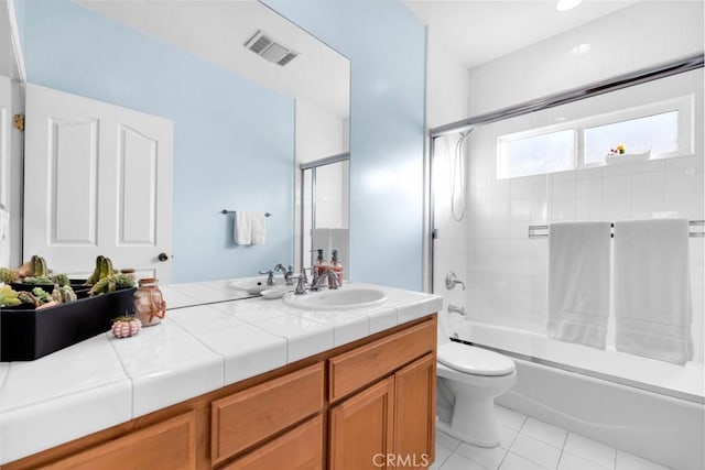 full bathroom with toilet, combined bath / shower with glass door, tile patterned floors, and vanity