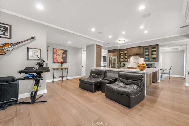 living room featuring light hardwood / wood-style floors and ornamental molding