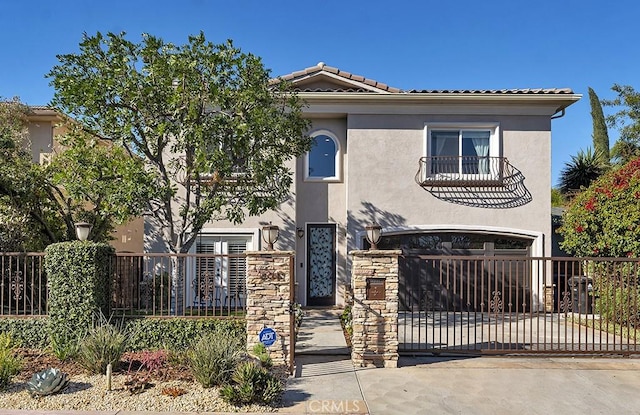 mediterranean / spanish-style home featuring a balcony and a garage