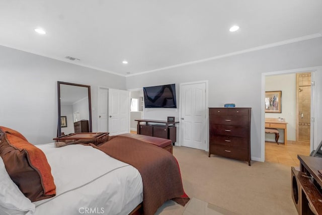 bedroom with light carpet, crown molding, and connected bathroom