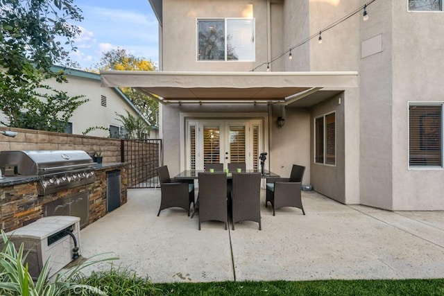 view of patio with french doors, grilling area, and area for grilling