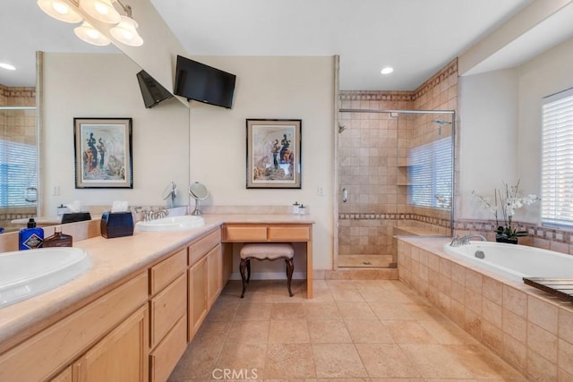 bathroom with plus walk in shower, vanity, a healthy amount of sunlight, and tile patterned flooring