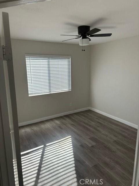 unfurnished room with ceiling fan and dark hardwood / wood-style flooring