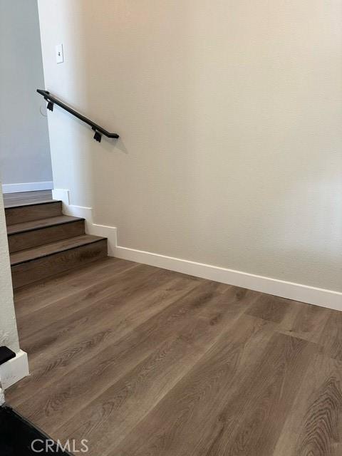 stairway featuring wood-type flooring