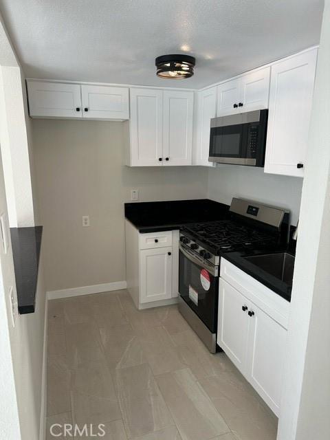 kitchen featuring sink, white cabinetry, and stainless steel appliances