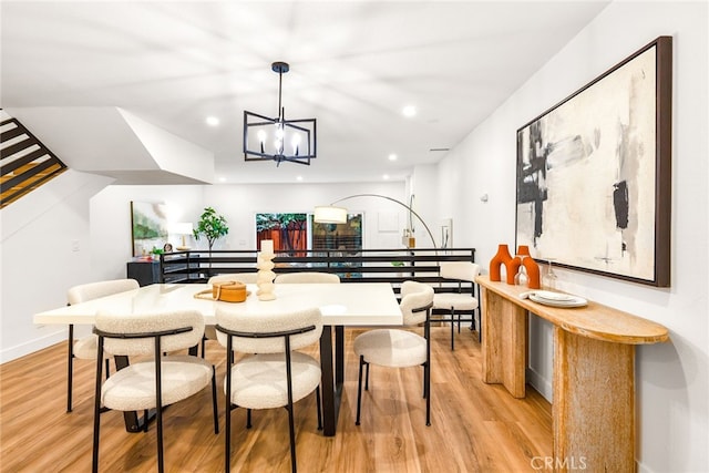 dining room with a chandelier, stairs, light wood-style flooring, and recessed lighting