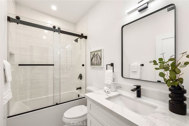 full bathroom with vanity, toilet, and bath / shower combo with glass door