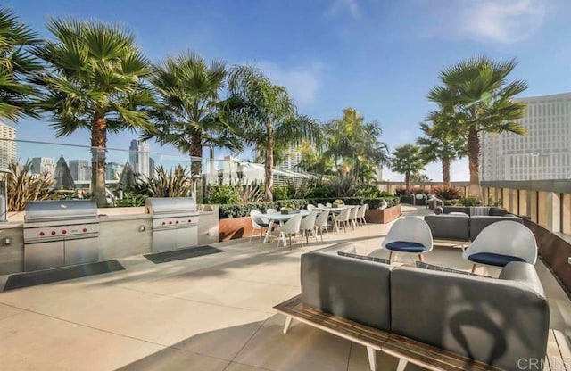 view of patio / terrace with exterior kitchen, outdoor lounge area, and a grill