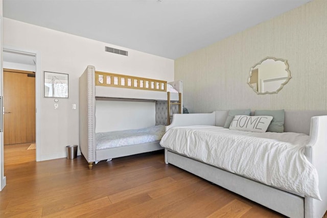 bedroom with hardwood / wood-style flooring