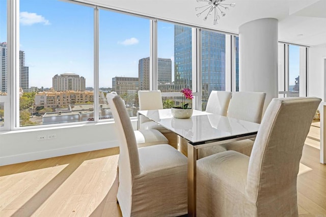 dining area featuring a notable chandelier and light hardwood / wood-style floors