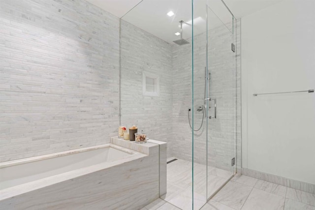 bathroom with shower with separate bathtub