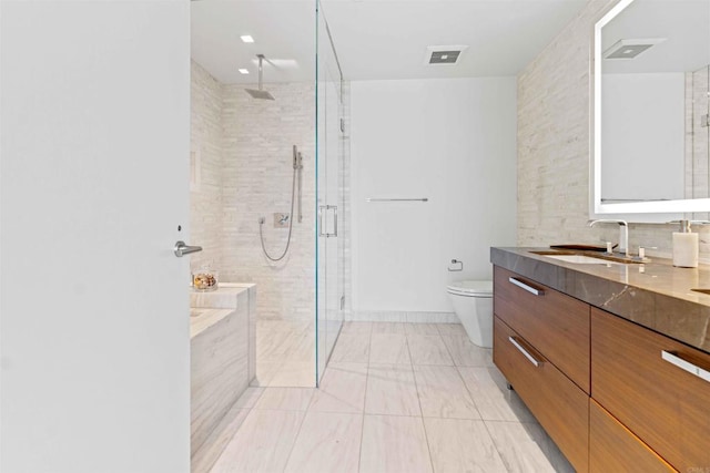 bathroom with tasteful backsplash, vanity, toilet, and an enclosed shower