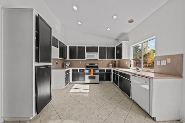 kitchen with lofted ceiling, sink, white appliances, tasteful backsplash, and light tile patterned flooring