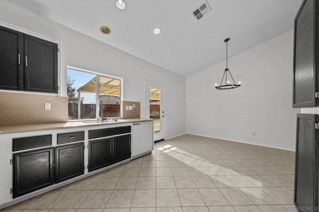 kitchen featuring decorative light fixtures, sink, a chandelier, light tile patterned floors, and white dishwasher