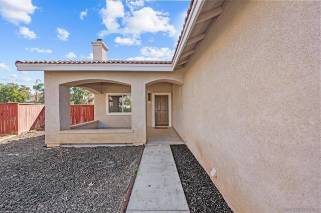 doorway to property with a patio area