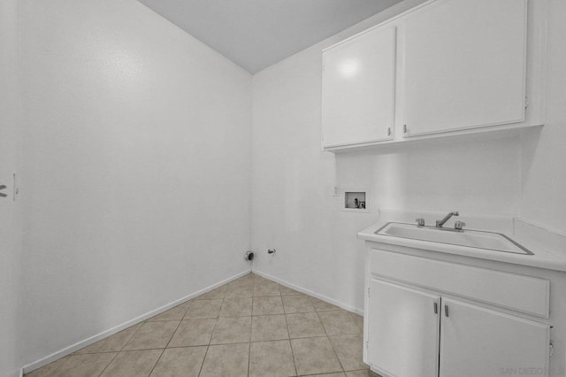 clothes washing area featuring sink, light tile patterned floors, hookup for a washing machine, cabinets, and hookup for a gas dryer