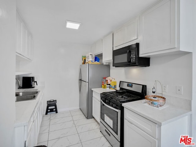 kitchen featuring appliances with stainless steel finishes, sink, and white cabinetry