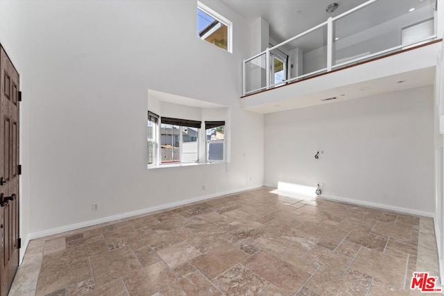 entryway with a wealth of natural light and a towering ceiling