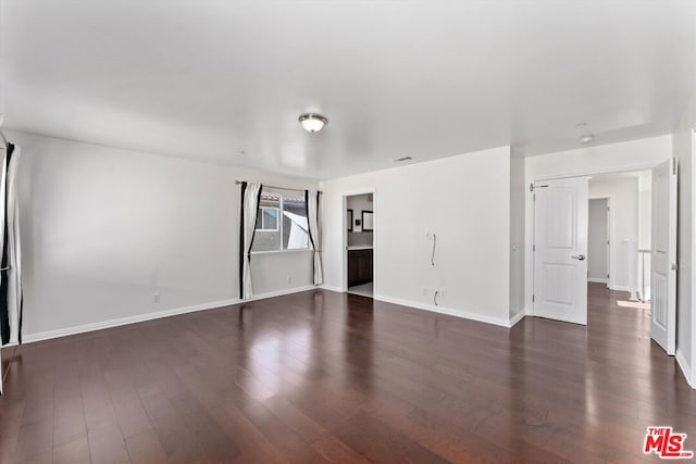 spare room featuring dark hardwood / wood-style floors