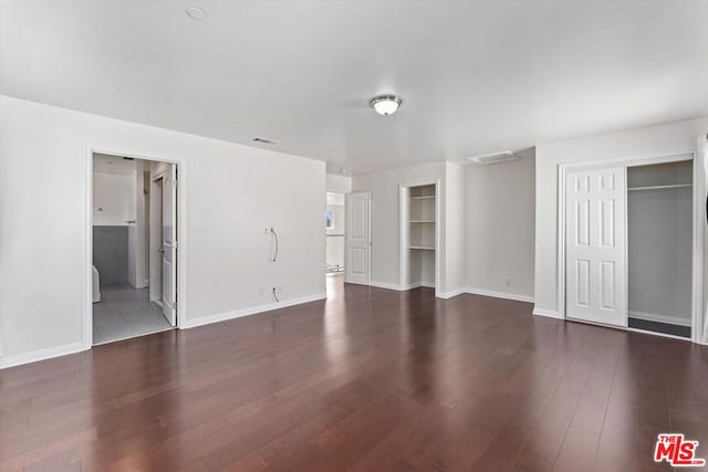 unfurnished living room featuring dark hardwood / wood-style flooring