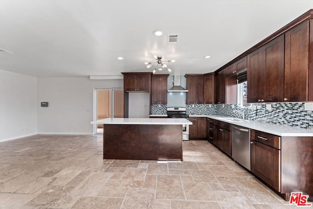 kitchen with wall chimney range hood, a kitchen island, sink, stainless steel appliances, and dark brown cabinets