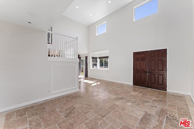 foyer entrance featuring a healthy amount of sunlight and a high ceiling