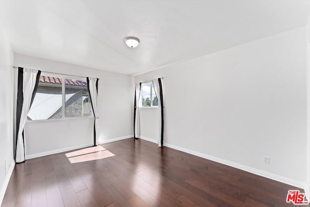 unfurnished bedroom with dark hardwood / wood-style flooring