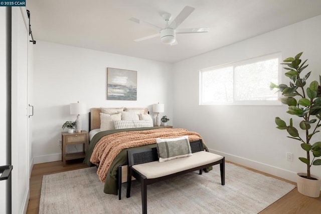 bedroom featuring hardwood / wood-style floors and ceiling fan