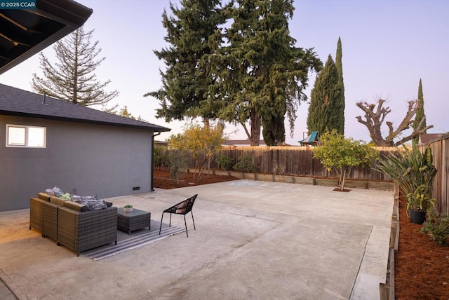 patio terrace at dusk featuring an outdoor living space