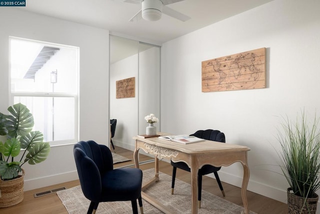 home office featuring hardwood / wood-style floors and ceiling fan