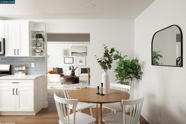 dining space with light wood-type flooring