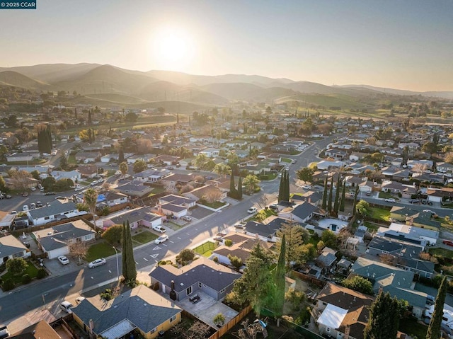 aerial view at dusk featuring a mountain view