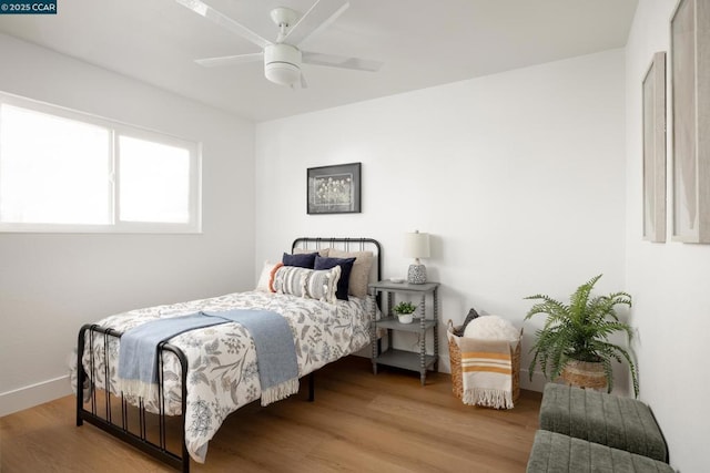 bedroom featuring ceiling fan and hardwood / wood-style flooring