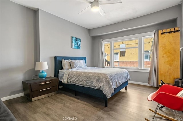 bedroom with ceiling fan and hardwood / wood-style floors