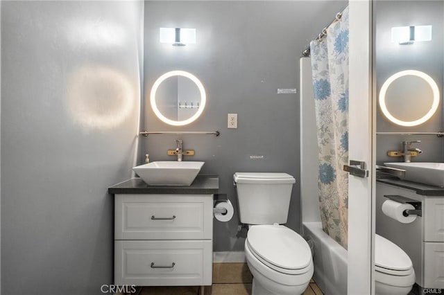 full bathroom with toilet, vanity, shower / tub combo, and tile patterned flooring