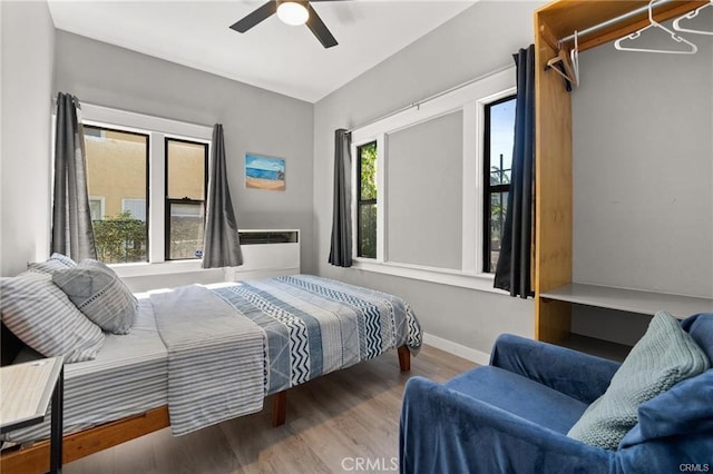 bedroom with ceiling fan and hardwood / wood-style floors