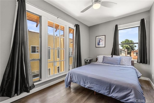 bedroom with ceiling fan and dark hardwood / wood-style floors