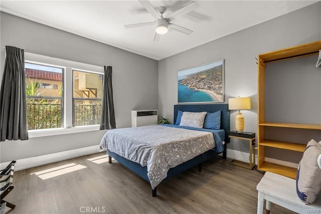 bedroom with ceiling fan and hardwood / wood-style floors