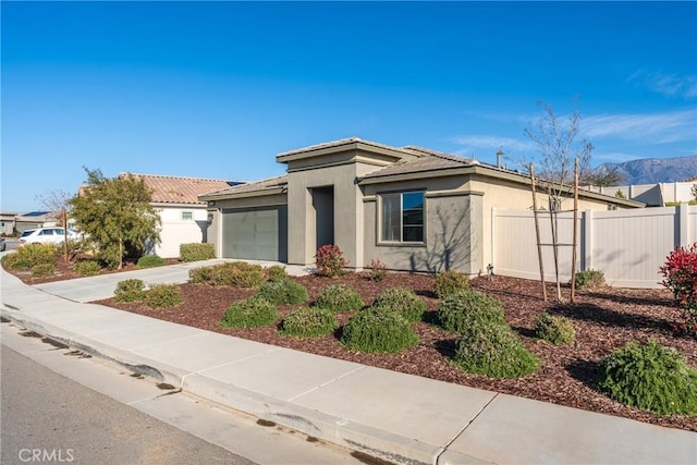 view of front of house featuring a garage and a mountain view