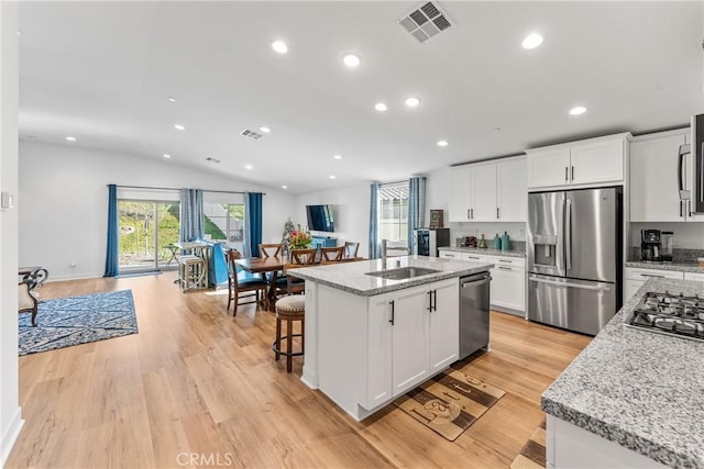 kitchen featuring sink, a center island with sink, white cabinets, and appliances with stainless steel finishes